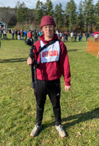 photo of me with an offical vest at a New England Cross Country meet