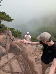 Walker taking a picture of me and Harrison climbing up the rocks