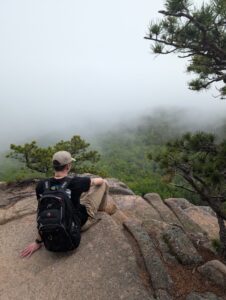 Photo of Harrison sitting over the ledge