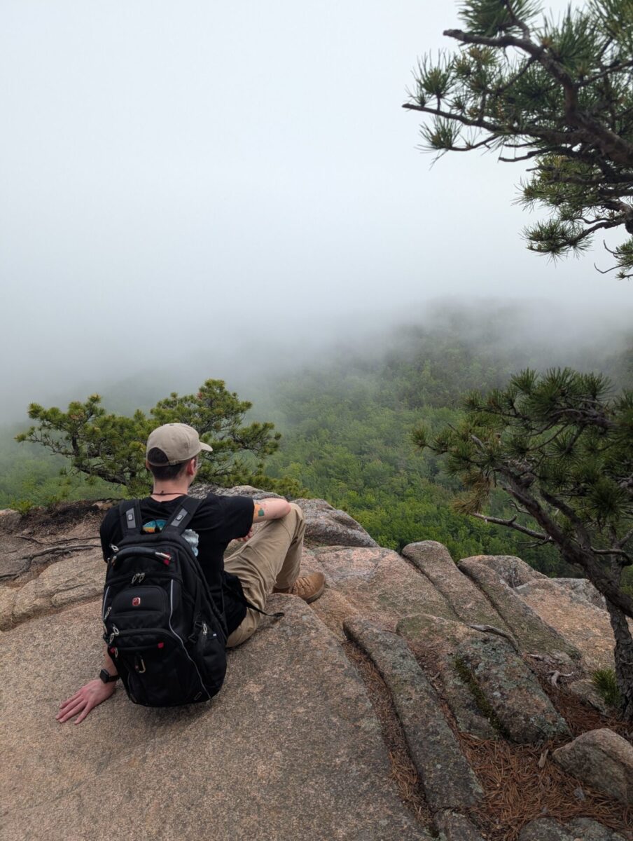 Photo of Harrison sitting over the ledge