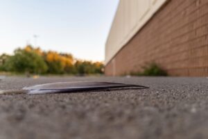 A close-up of a feather on an empty mall sidewalk