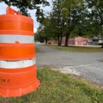 a orange cone sat next to crossroads