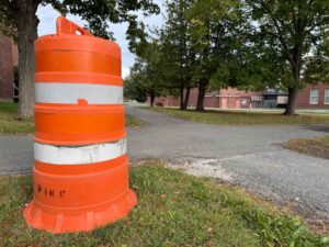 a orange cone sat next to crossroads