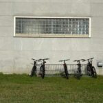 student bikes up against a dorm hall exterior